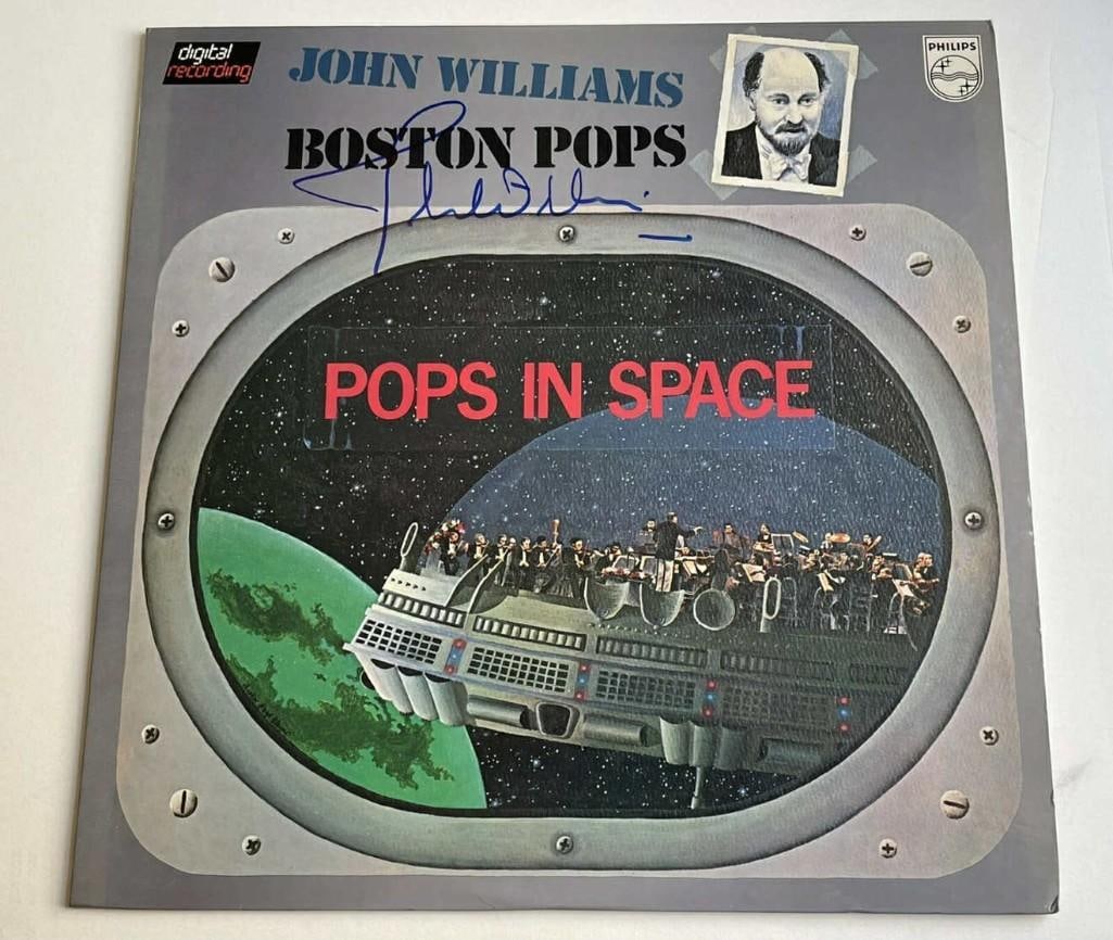 John Williams Signed "Pops in Space" Album (SWAU Authentication): "Pops in Space" album signed on the cover in blue felt tip marker by film composer John Williams. Measuring approximately 12" x 12" and in fine condition. Accompanied by a SWAU Letter of Authenti