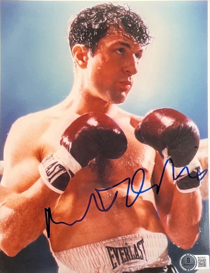 Raging Bull: Robert De Niro Signed Photo (Beckett/BAS Authentication): Color 10" x 8" photo from the 1980 film "Raging Bull," signed in blue felt tip marker by actor Robert De Niro. In fine condition. Authenticated by Beckett/BAS, with their official hologram affixed to