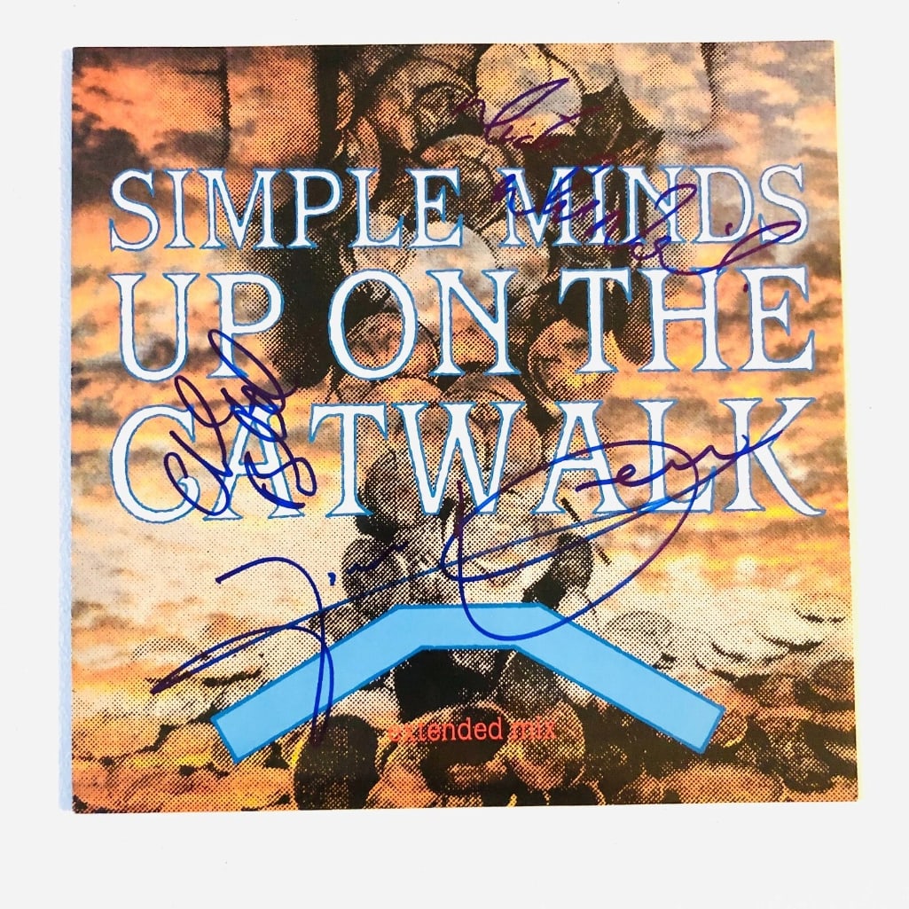 Simple Minds Group Signed "Up on the Catwalk" LP Album (3 Sigs) (BAS): "Up on the Catwalk" LP album signed on the cover in blue felt tip marker by Simple Minds band members Jim Kerr, Charles Burchill, and Mick MacNeill. Measuring approximately 12" x 12" and in fine