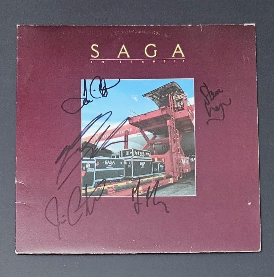 Saga Classic Lineup Group Signed "In Transit" Album (5 Sigs) (Third Party Guaranteed): "In Transit" album signed on the cover in black felt tip marker by Saga original lineup band members Michael Sadler, Ian Crichton, Jim Gilmour, Jim Crichton, and Steve Negus. Measuring approximately