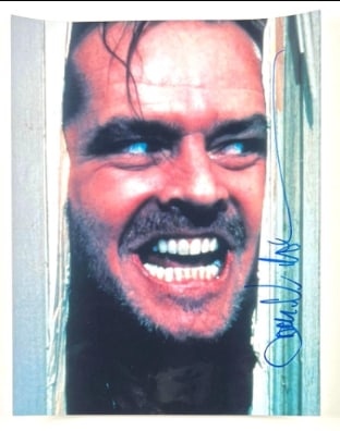 Jack Nicholson Signed 11" x 14" "The Shining" "Here's Johnny" Photo (Beckett/BAS Authentication): Color 11" x 14" photo of Jack Torrance from the film "The Shining" signed in blue felt tip marker by actor Jack Nicholson. In fine condition. Obtained in-person. Accompanied by a full Letter of