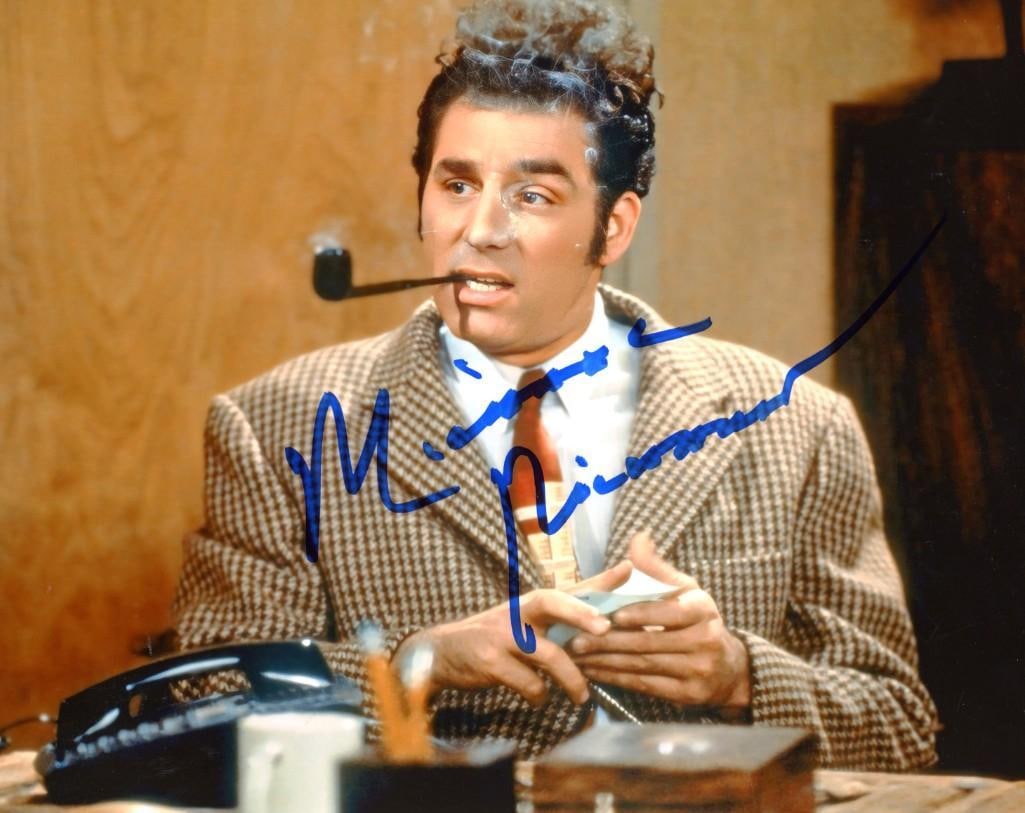 Seinfeld: Michael Richards Signed 8" x 10" Photo as Cosmo Kramer (ACOA Authentication): Color 8" x 10" photo of Cosmo Kramer from the show "Seinfeld" signed in blue felt tip marker by actor Michael Richards. In fine condition. Obtained in-person. Accompanied by an ACOA certification