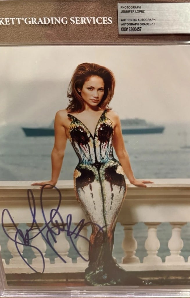 Jennifer Lopez Signed Slabbed Photo (Beckett/BAS Authentication): Color slabbed 10" x 8" photo signed in blue felt tip marker by actress and musician Jennifer Lopez, graded a perfect Gem Mint 10. In fine condition. Encapsulated and authenticated by Beckett/BAS