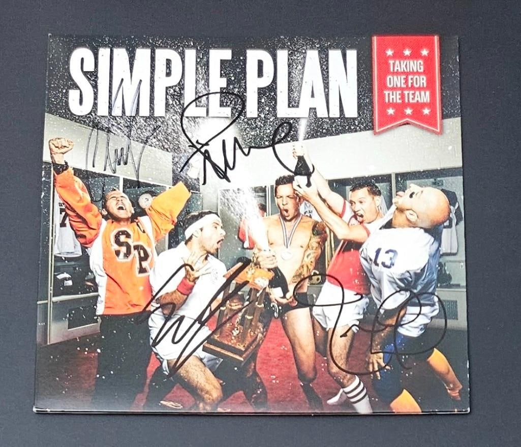 Simple Plan Group Signed "Taking One For the Team" Album (4 Sigs) (Third Party Guaranteed): "Taking One For the Team" album signed on the cover in black felt tip marker by Simple Plan band members Pierre Bouvier, Chuck Comeau, Jeff Stinco, and Sebastien Lefebvre. Measuring approximately 12"