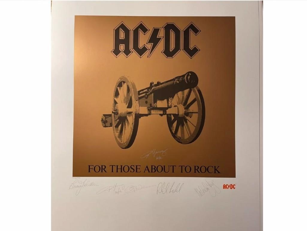 AC/DC: Angus Young Signed 28" x 22" "For Those About to Rock" Lithograph (Third Party Guaranteed): Color 28" x 22" "For Those About to Rock" lithograph signed in silver felt tip marker by AC/DC band member Angus Young. Pre-printed signatures of AC/DC band members Brian Johnson, Angus Young, Phil Ru