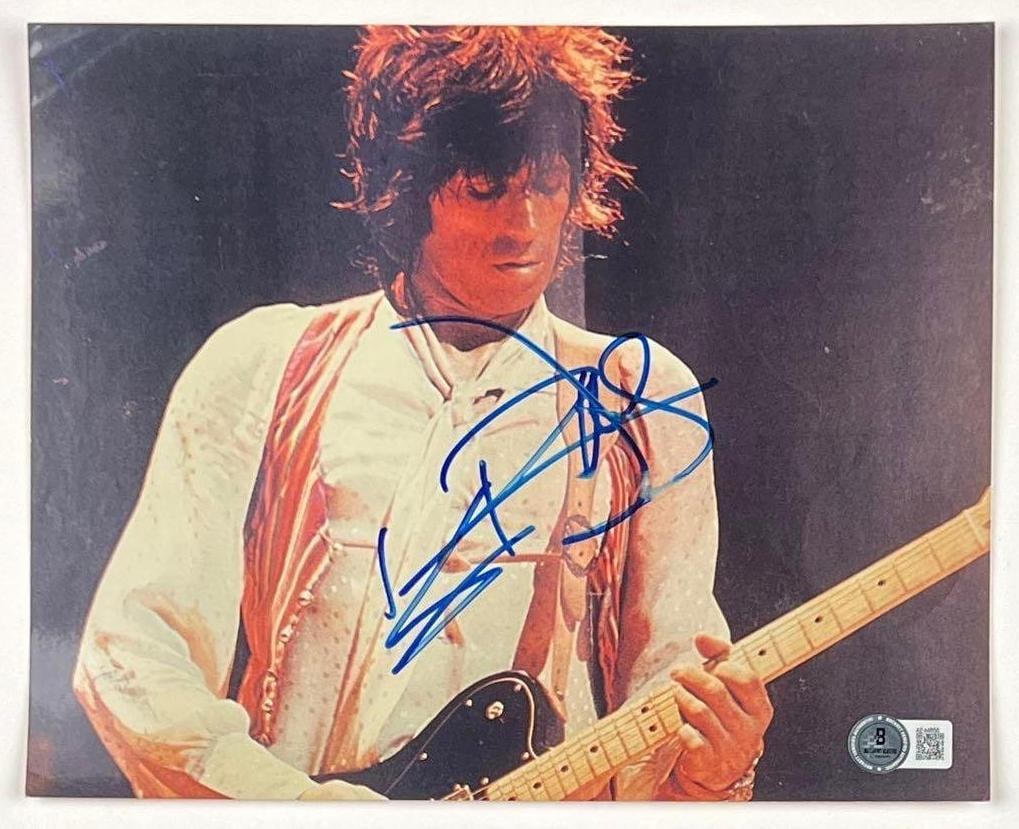 The Rolling Stones: Keith Richards Signed 8" x 10" Photo (Beckett/BAS Authentication): Color 8" x 10" photo signed in blue felt tip marker by Rolling Stones band member Keith Richards. In very good condition, with some signs of scattered wear, including some slight surface scratching.