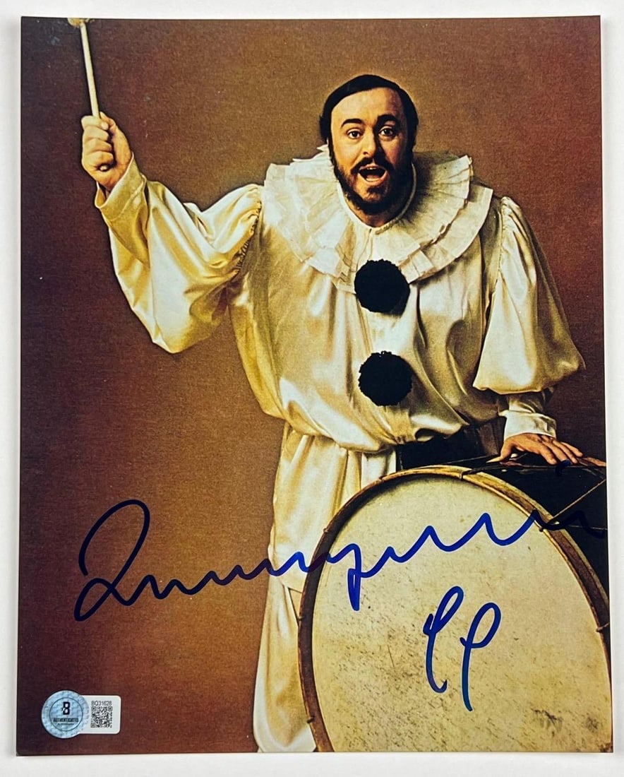 Luciano Pavarotti Signed 10" x 8" Photo (Beckett/BAS Authentication): Color 10" x 8" photo signed in blue felt tip marker by singer Luciano Pavarotti. In fine condition. Obtained in-person. Authenticated by Beckett/BAS, with their official hologram affixed to the front