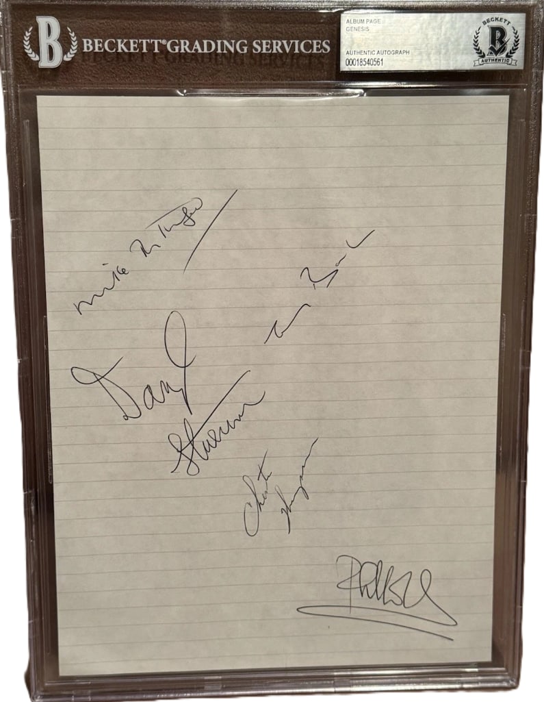 Genesis Group Signed Slabbed 10" x 7.5" Album Page (5 Sigs) (Beckett/BAS Authentication): White lined slabbed 10" x 7.5" album page signed in black ballpoint pen by Genesis band members Mike Rutherford, Tony Banks, Phil Collins, Chester Thompson, and Daryl Stuemer. In fine condition.