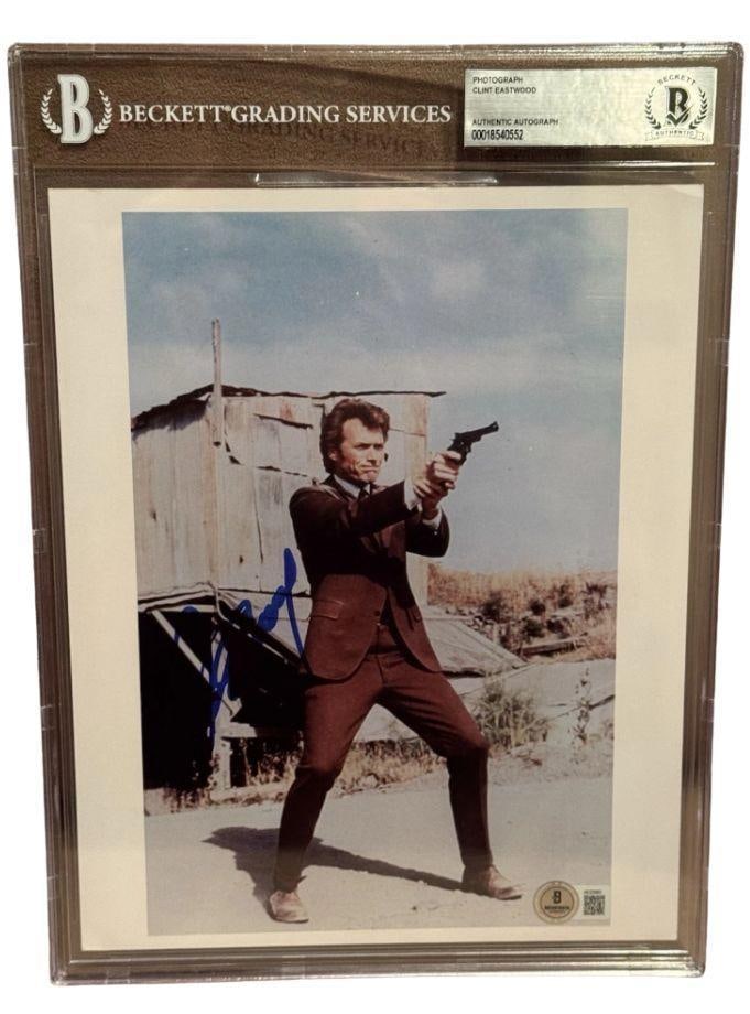Dirty Harry: Clint Eastwood Signed Slabbed 10" x 8" Photo as Harry Callahan (Beckett/BAS): Color 10" x 8" photo of the character Harry Callahan from the film "Dirty Harry" signed in blue felt tip marker by actor Clint Eastwood. In fine condition. Encapsulated and authenticated by