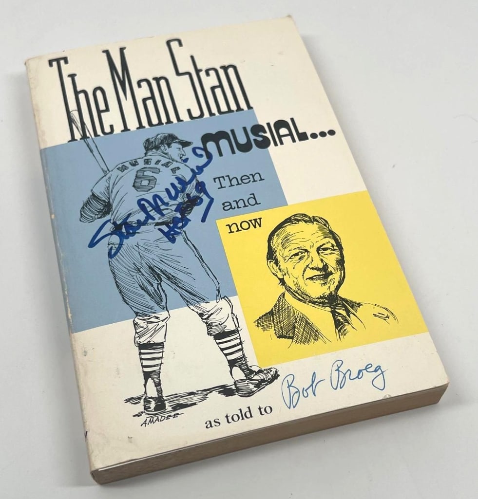 Stan Musial Signed "The Man Stan Musial...Then and Now" Book (Third Party Guaranteed): Softcover copy of The Man Stan Musial... Then and Now signed in bold blue marker on the front cover by Hall of Famer Stan Musial. The book, written by sportswriter Bob Broeg, contains 253 pages and me