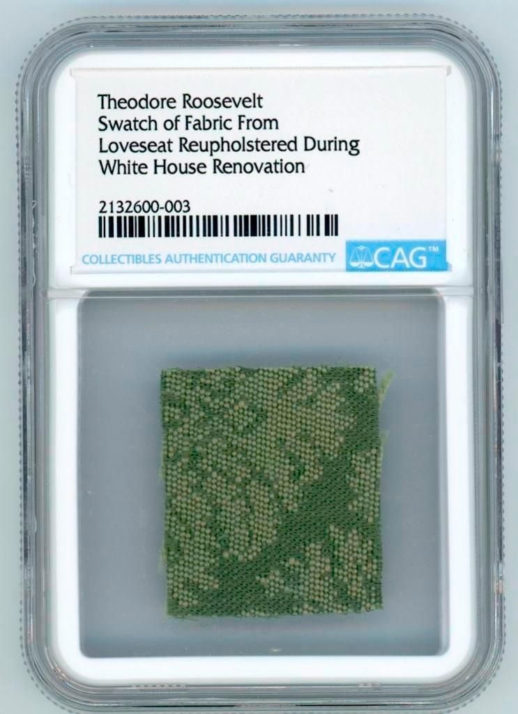 Theodore Roosevelt White House Loveseat Silk Fragment (CAG): Encapsulated silk brocade fragment, approximately 1" x 1", from a White House loveseat likely installed during Theodore Roosevelt’s 1902 renovation and removed in 1954 under First Lady Mamie Eis