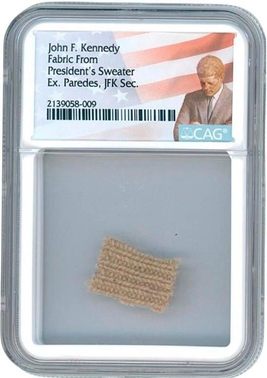 John F. Kennedy Swatch from Mink-Collared Cashmere Sweater (CAG Encapsulated): Swatch of cashmere, .75" x .5," cut from a mink-collared sweater personally owned by President John F. Kennedy. Encapsulated by CAG to an overall size of 2.375'' x 3.375''. The sweater was gifted to P