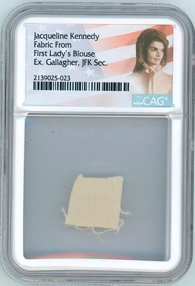 Jacqueline Kennedy Worn Blouse Fabric Swatch (CAG Encapsulated): Silk fabric swatch, 0.5" x 0.5" from a blouse personally owned and worn by First Lady Jacqueline Kennedy. The blouse was gifted to longtime personal secretary Mary Barelli Gallagher and sold at