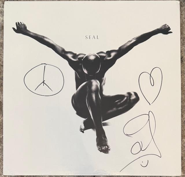 Seal Signed Sealed Limited Edition "Seal II" Album (Third Party Guaranteed): "Seal II" sealed limited edition album signed on the cover in black felt tip marker by musician Seal, who also sketched a peace symbol and a heart above his signature. Measuring approximately 12" x