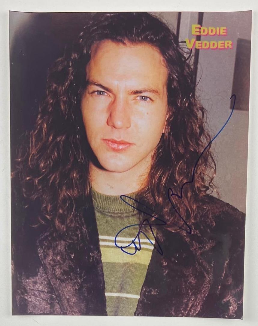 Pearl Jam: Eddie Vedder Signed 14" x 11" Photo (Beckett/BAS Authentication): Color 14" x 11" photo signed in blue felt tip marker by Pearl Jam front man Eddie Vedder. In fine condition. Obtained in-person. Accompanied by a full Letter of Authenticity from Beckett/BAS (#AE06699