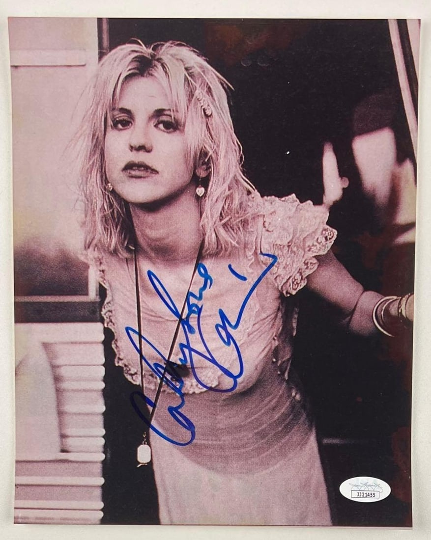 Courtney Love Cobain Signed 10" x 8" Photo (JSA Authentication): Black-and-white 10" x 8" photo signed in blue felt tip marker by Hole front woman Courtney Love, who signed her married name, Courtney Love Cobain. In fine condition. Obtained in-person. Accompanied