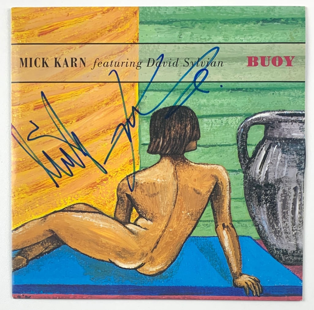 Japan: Mick Karn Signed "Buoy" 45 (Beckett/BAS Authentication): "Buoy" 45 signed on the cover in blue felt tip marker by Japan band member Mick Karn. Measuring approximately 7" x 7" and in fine condition. Record is included. Obtained in-person. Accompanied by a Be
