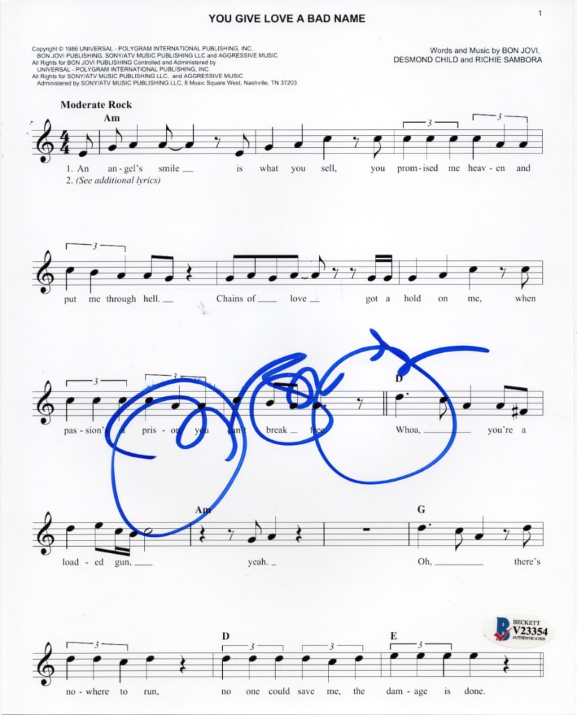 Jon Bon Jovi Signed 10" x 8" "You Give Love a Bad Name" Lyric Sheet (Beckett/BAS Authentication): White lined 10" x 8" "You Give Love a Bad Name" lyric sheet printed on photo paper and signed in blue felt tip marker by musician Jon Bon Jovi. In fine condition. Obtained in-person. Authenticated by