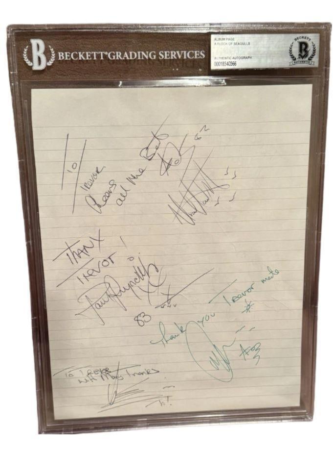 Simple Minds Group Signed Slabbed 10" x 7.5" Album Page (4 Sigs) (Beckett/BAS): White lined slabbed 10" x 7.5" album page signed in black ballpoint pen by Simple Minds band members Charlie Burchill, Derek Forbes, Mel Gaynor, and Mick MacNeil. In fine condition. Encapsulated and a