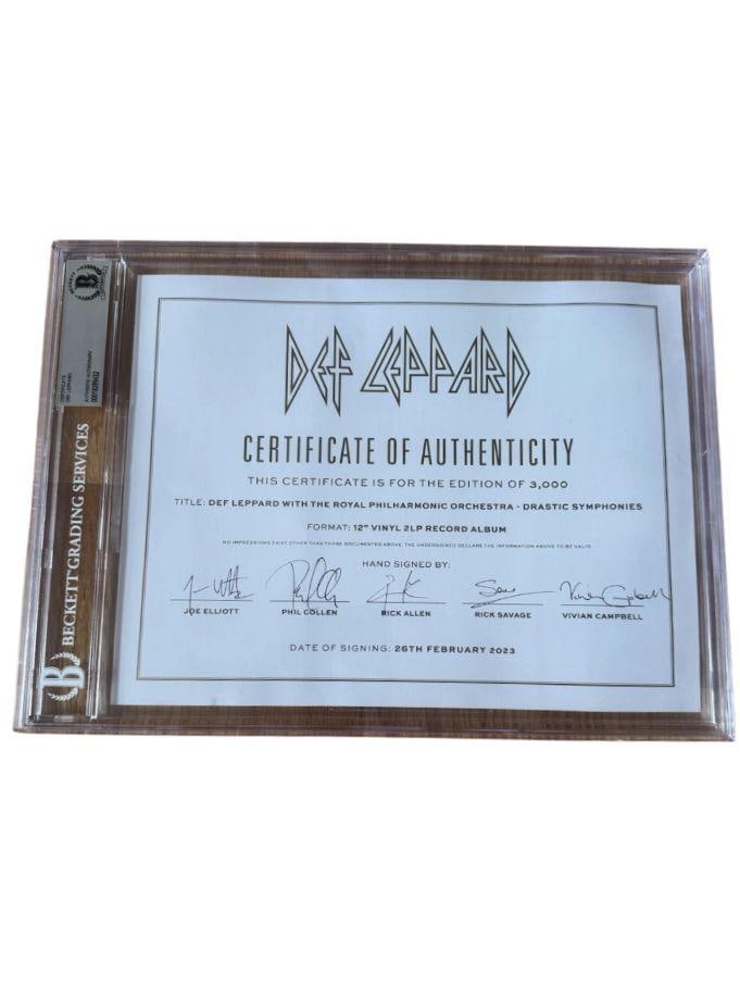 Def Leppard Group Signed Slabbed 8.5" x 11" Certificate of Authenticity (5 Sigs) (Beckett/BAS): White slabbed 8.5" x 11" Certificate of Authenticity signed in black felt tip marker by Def Leppard band members Rick Allen, Joe Elliott, Phil Collen, Rick Savage, and Vivian Campbell. In fine