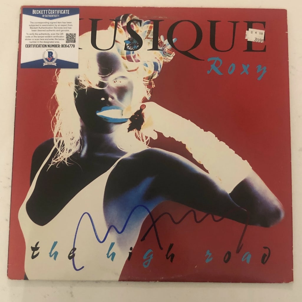 Roxy Music: Bryan Ferry Signed "Musique" LP Album (Beckett/BAS Authentication): "Musique" LP album signed on the cover in blue felt tip marker by Roxy Music front man Bryan Ferry. Measuring approximately 12" x 12" and in fine condition. Obtained in-person. Record is included.