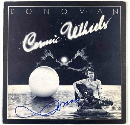 Donovan Signed "Cosmic Wheels" Album (Beckett/BAS Authentication): "Cosmic Wheels" album signed on the front cover in blue felt tip marker by musician Donovan, and also on the inner gatefold by two others. Measuring approximately 12" x 12" and in very good