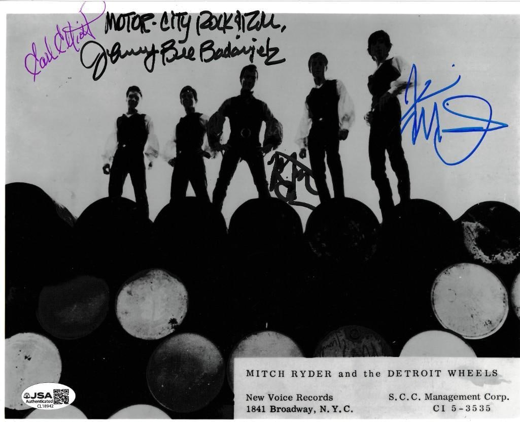 Mitch Ryder & the Detroit Wheels Group Signed 8" x 10" Photo (4 Sigs) (JSA Authentication): Black-and-white 8" x 10" photo signed in black, blue, and purple felt tip markers by Mitch Ryder, and his backup band the Detroit Wheels band members Earl Elliott, Johnny Bee Badanjek, Mitch Ryder,