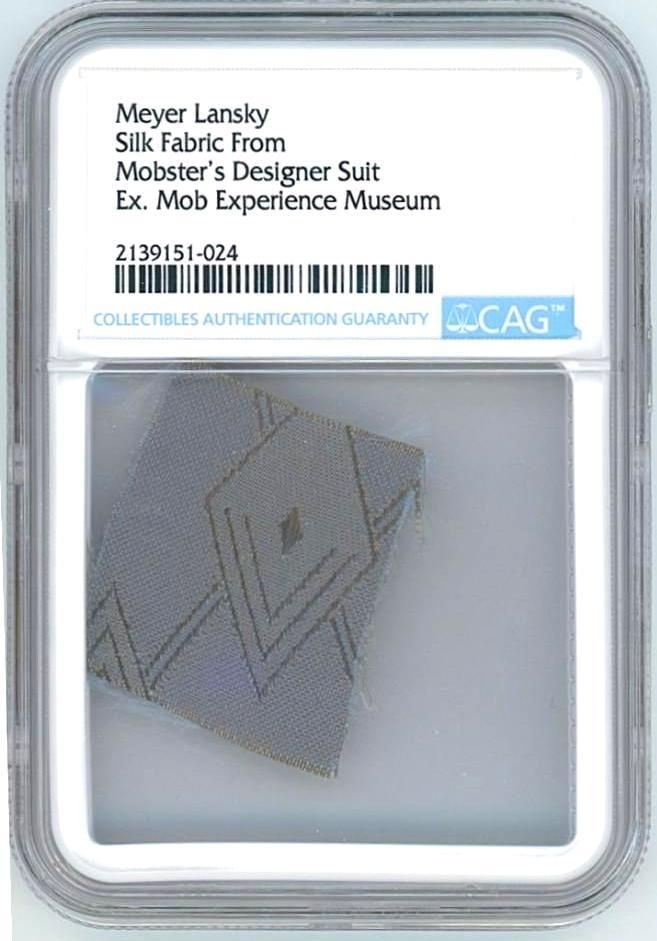 Meyer Lansky Swatch from Personally Owned Designer Suit (CAG Encapsulated): Silk swatch, 1.25" x 1," cut from a custom designer suit personally owned by mobster Meyer Lansky. Encapsulated by CAG to an overall size of 2.375'' x 3.375''. Sourced from the Mob Experience Museum,