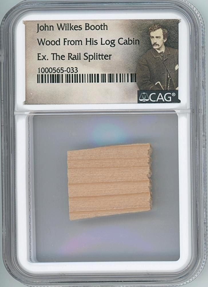 John Wilkes Booth’s Birthplace Cabin Wooden Fragment Artifact (CAG Encapsulated): Wooden fragment, 0.75" x 1," taken from the original "Booth Cabin" in Bel Air, Maryland—birthplace of John Wilkes Booth. Encapsulated by CAG to 2.5" x 3.5" and includes an extensive provenance