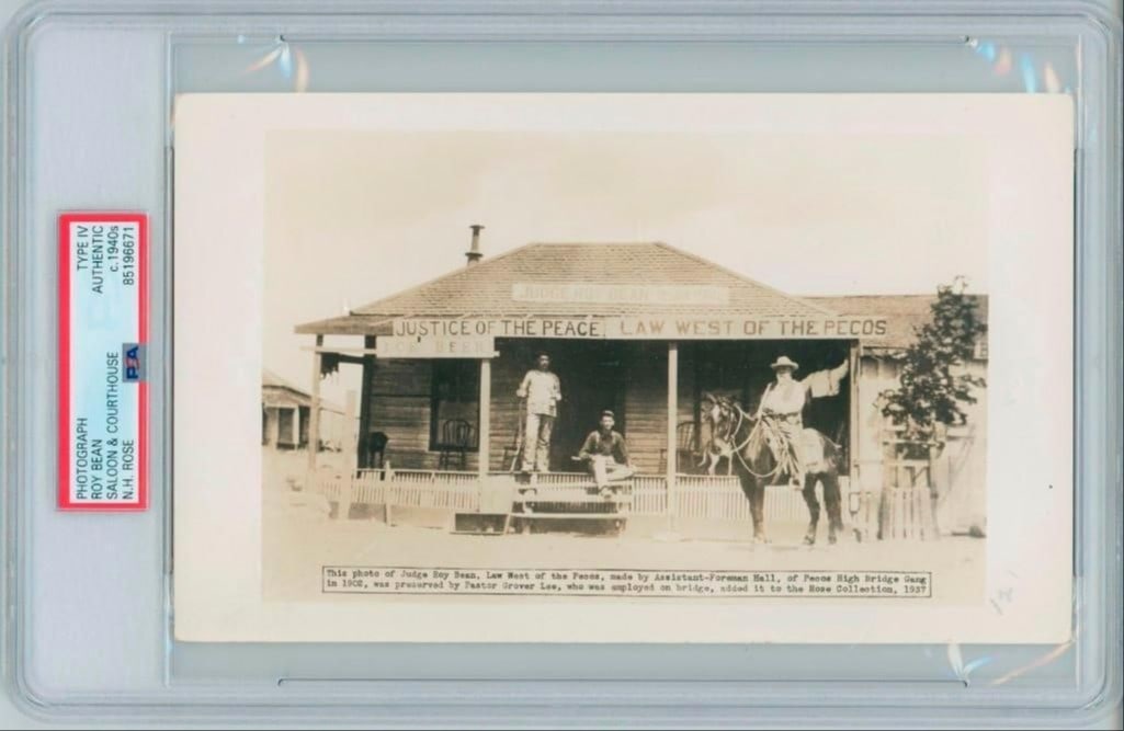 Judge Roy Bean “Law West of the Pecos” 5" x 8" Vintage Photo (PSA Authentication): Vintage 5" x 8" sepia photo of the famed Judge Roy Bean in front of his legendary saloon-courthouse in Langtry, Texas. Bean is seen on horseback outside the building, which bears the iconic sign,