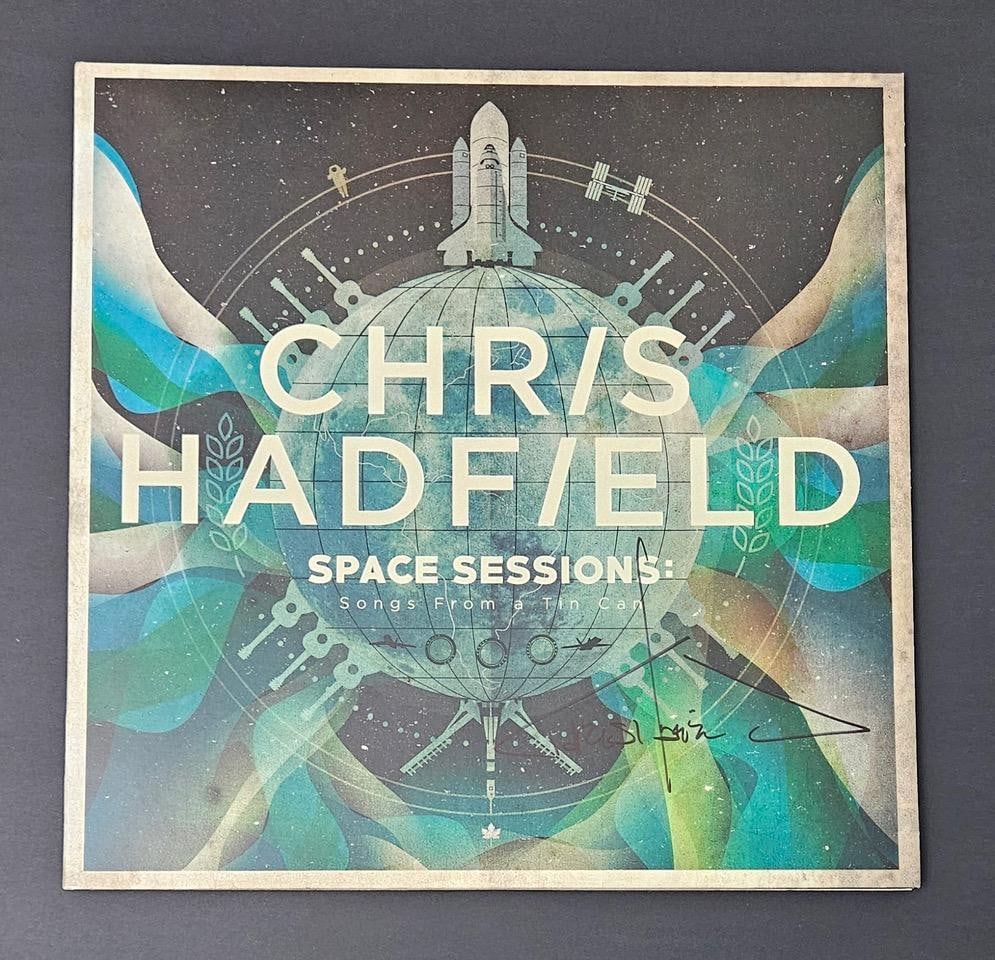 Chris Hadfield Signed "Space Sessions" Album (Third Party Guaranteed): "Space Sessions" album signed on the cover in black felt tip marker by musician Chris Hadfield. Measuring approximately 12" x 12" and in fine condition.ProvenanceEaton & Brennan Auctions guarantees