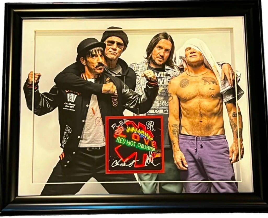 Red Hot Chili Peppers Group Signed "Unlimited Love" CD Inside 19" x 23" Framed Display (4 Sig) (BAS): "Unlimited Love" CD signed on the cover in silver felt tip marker by the Red Hot Chili Peppers band members Anthony Kiedis, Flea, Chad Smith, and John Frusciante. Measuring approximately 5" x 5" and