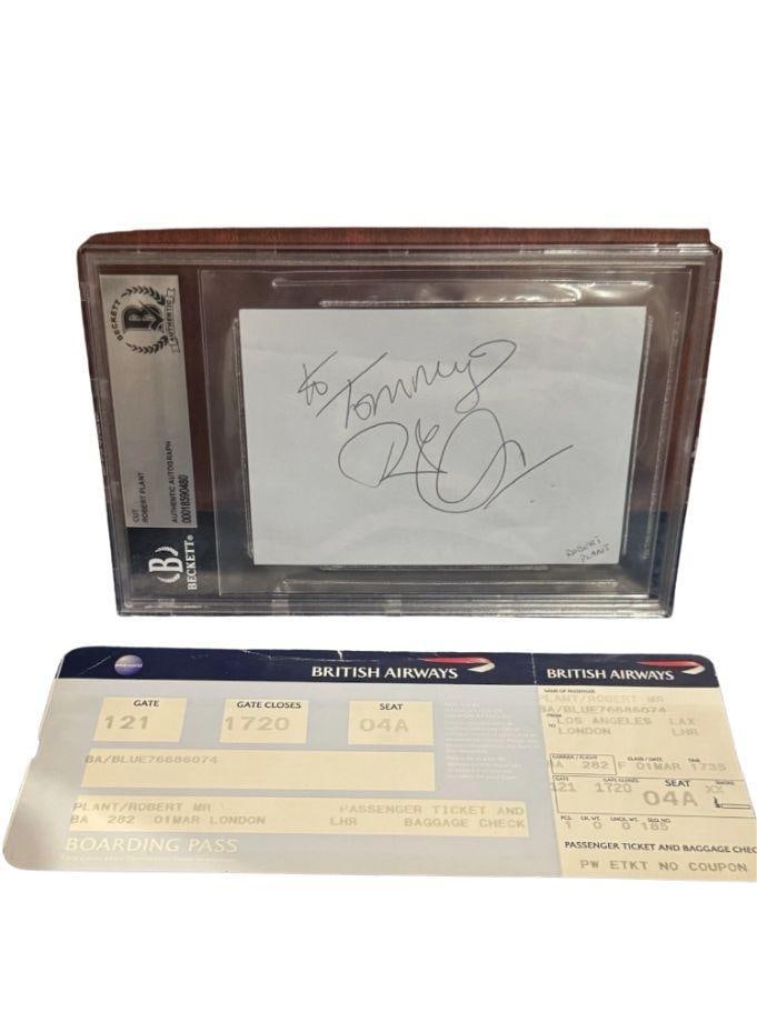 Led Zeppelin: Robert Plant Signed Slabbed 3" x 4.5" Cut & Boarding Pass (Beckett/BAS): White slabbed 3" x 4.5" cut signed in black ballpoint pen by Led Zeppelin band member Robert Plant, who inscribed the message "To Tommy," before his signature. Plant's name is printed in pencil on