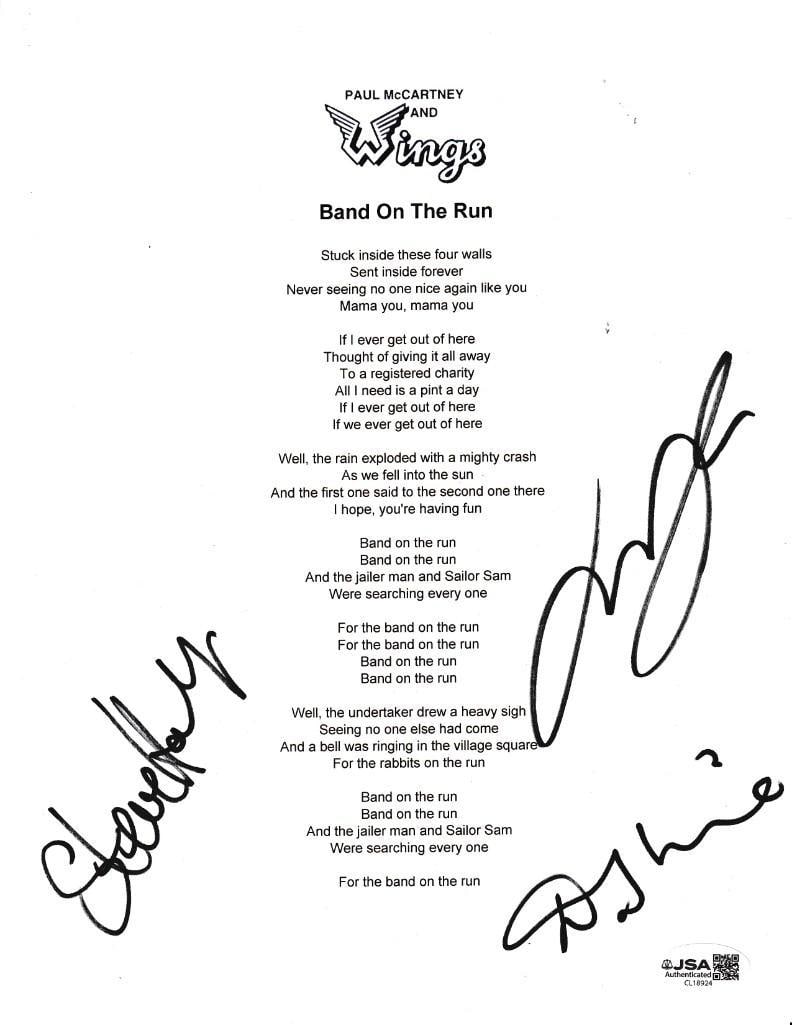 Wings Group Signed 10" x 8" "Band on the Run" Printed Lyric Sheet (3 Sigs) (JSA): White 10" x 8" "Band on the Run" printed lyric sheet signed in black felt tip marker by Wings band members Denny Laine, Steve Holley, and Laurence Juber. In fine condition. Authenticated by JSA, with