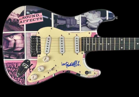The Jam: Paul Weller In-Person Signed "Sound Affects" Themed Fender-Style Guitar (Beckett): Custom electric Fender-style guitar themed after The Jam’s influential album "Sound Affects," signed on the pickguard in blue felt tip marker by Paul Weller. Measuring approximately 13” x 