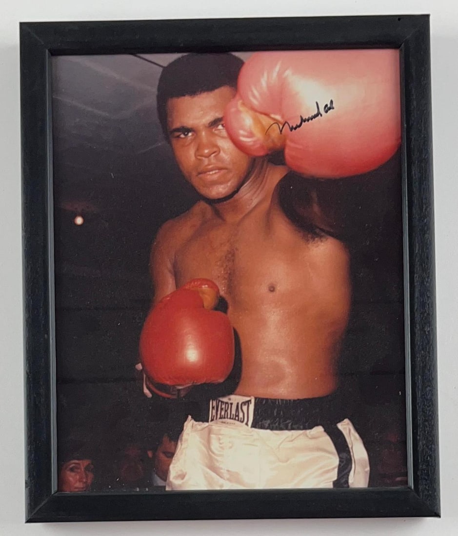 Muhammad Ali Signed 11" x 9" Framed Photo (Third Party Guaranteed): Color 11" x 9" framed photo signed in black felt tip marker by boxer Muhammad Ali. In fine condition. Provenance Eaton & Brennan Auctions guarantees this lot to pass Third-Party Authentication. Please