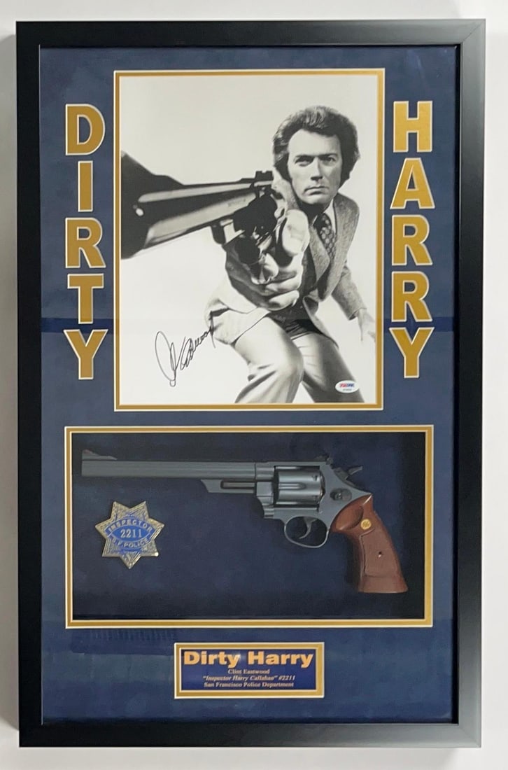 Clint Eastwood Signed "Dirty Harry" Poster & Pistol in Frame (PSA/DNA): Color 30.75" x 19.5" framed poster from the film "Dirty Harry" signed in black felt tip marker by actor Clint Eastwood. Signed poster measures 14" x 10.75" and is displayed along with a real metal