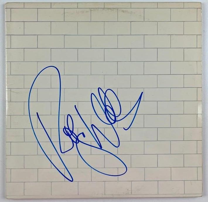 Pink Floyd: Roger Waters Signed "The Wall" Album (Beckett Authentication): "The Wall" album signed on the cover in blue felt tip marker by Pink Floyd band member Roger Waters. Measuring approximately 12" x 12" and in fine condition. Record is included. Obtained in-person.