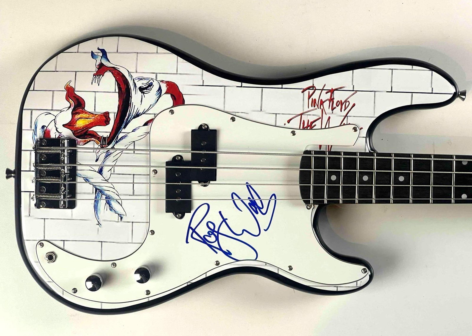 Pink Floyd: Roger Waters In-Person Signed Custom Bass Guitar w/ “The Wall” Album Artwork: Custom bass guitar featuring striking imagery from Pink Floyd’s landmark 1979 album "The Wall," including the infamous screaming face and signature brick motif. Boldly signed on the white