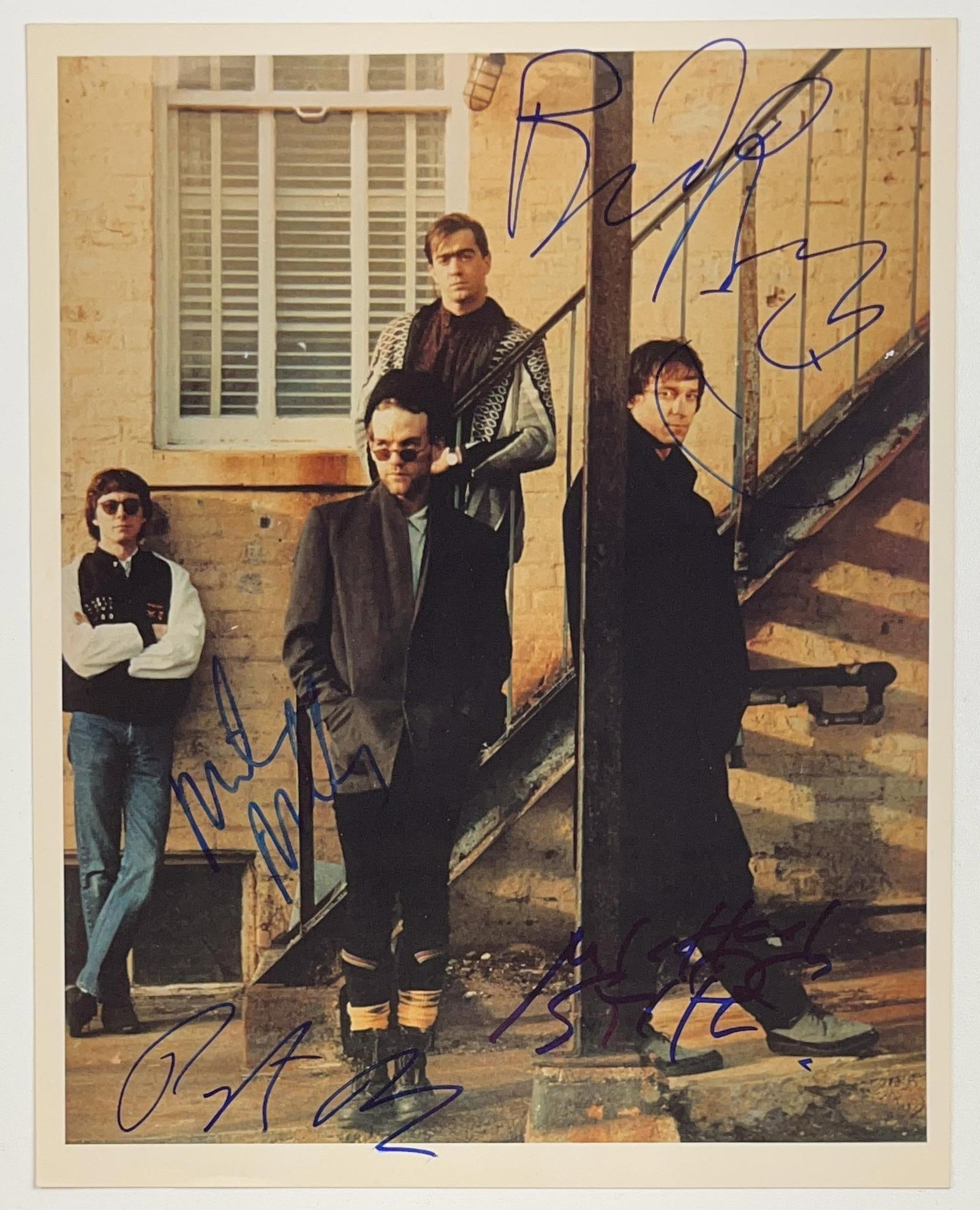 R.E.M. Group Signed 10" x 8" Photo (4 Sigs) (Beckett Authentication): Sought-after color 10" x 8" photo signed in blue felt tip marker by R.E.M. band members Michael Stipe, Bill Berry, Peter Buck, and Michael Mills. In fine condition. Accompanied by a full Letter of Aut