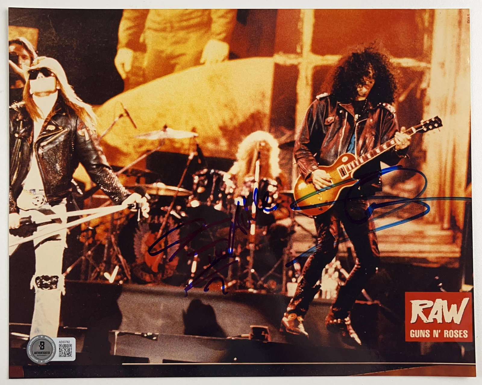 Guns N' Roses: Slash & Steven Adler Signed 8" x 10" Photo (2 Sigs) (Beckett Authentication): Color 10" x 8" photo signed in blue felt tip marker by Guns N' Roses band members Slash and Steven Adler. In fine condition. Accompanied by a full Letter of Authenticity from Beckett (#AE63782). Prove