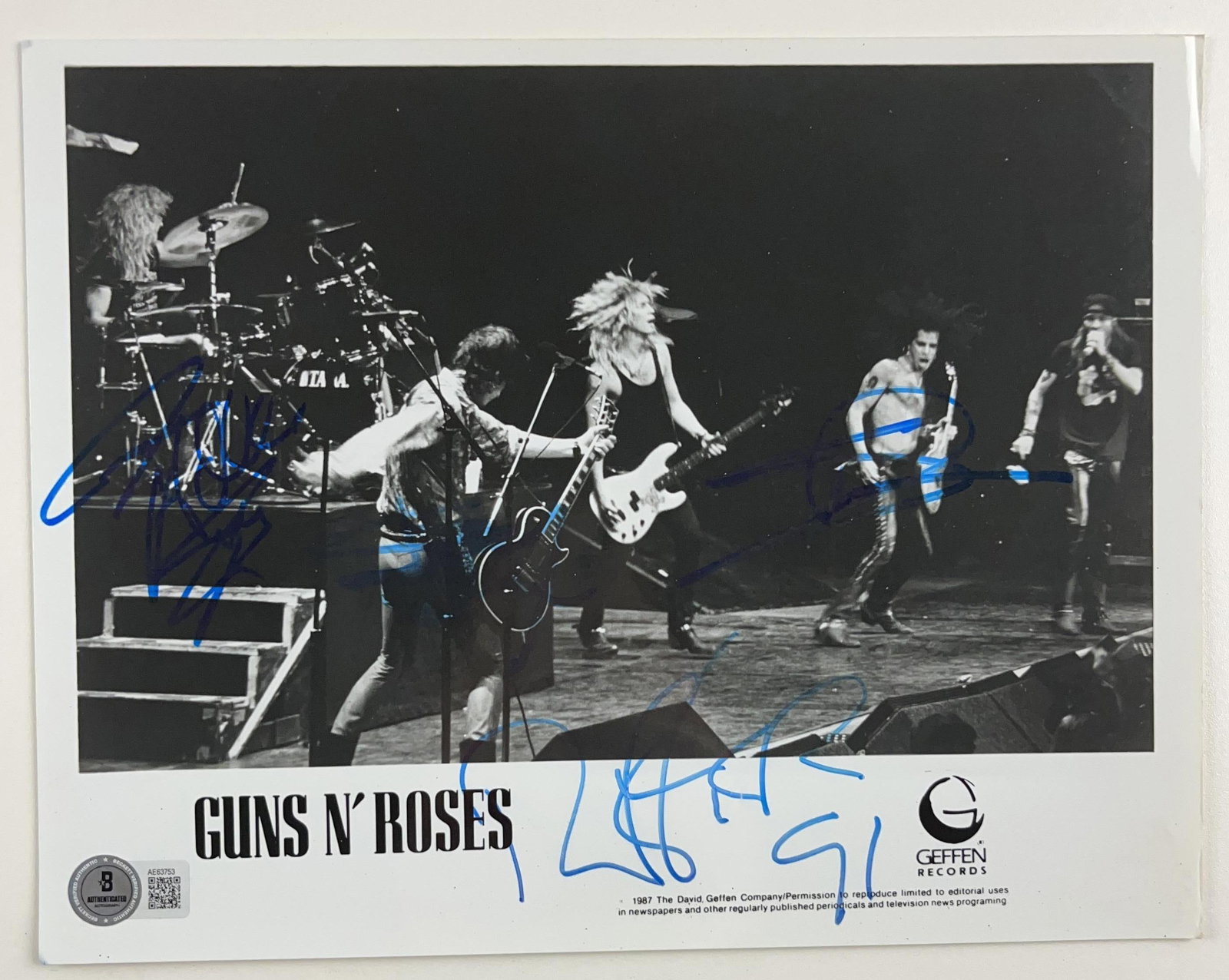 Guns N' Roses Group Signed 8" x 10" Promo Photo (4 Sigs) (Beckett Authentication): Scarce black-and-white 8" x 10" promotional photo signed in blue felt tip marker by Guns N' Roses members Slash, Duff McKagan, Izzy Stradlin, and Steven Adler. In fine condition. Accompanied by a
