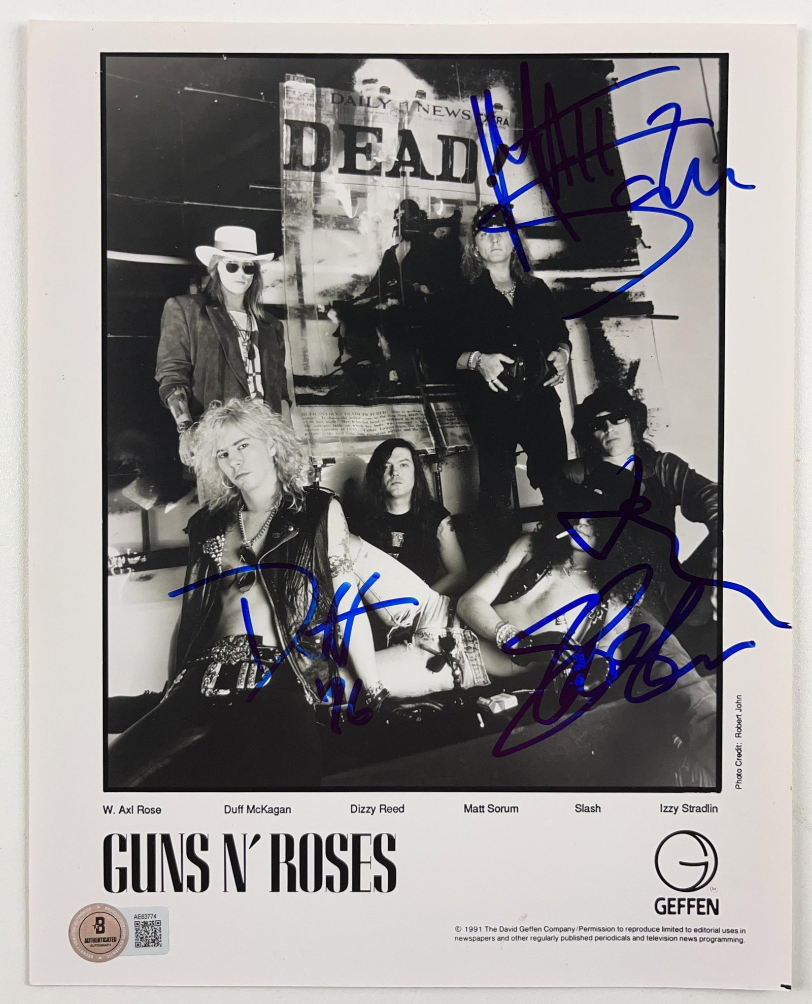 Guns N' Roses Group Signed 10" x 8 Promo Photo (3 Sigs) (Beckett Authentication): Black-and-white 10" x 8" promotional photo signed in blue felt tip marker by Guns N' Roses band members Slash, Duff McKagan, who inscribed the date "16" after his signature, and Matt Sorum. In fine co
