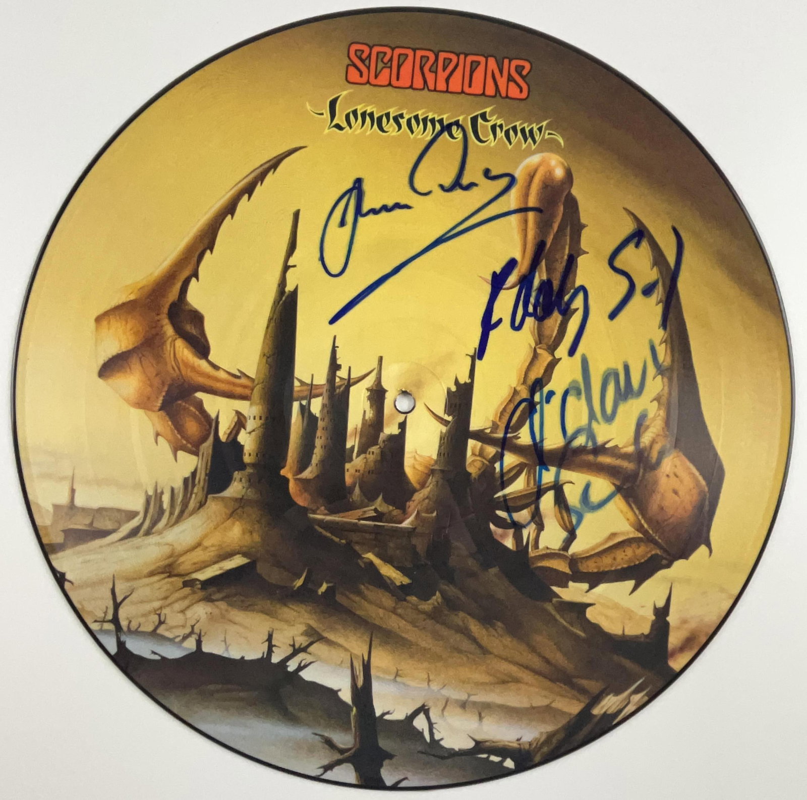 Scorpions Group Signed "Lonesome Crow" Picture Disc (3 Sigs) (Beckett Authentication): "Lonesome Crow" album picture disc signed on the cover in blue felt tip marker by Scorpions band members Rudolf Schenker, Michael Schenker, and Klaus Meine. Measuring approximately 12" x 12" and in fi