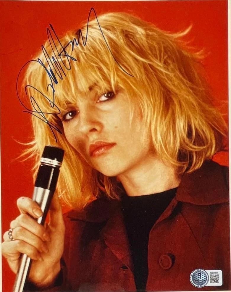 Blondie: Debbie Harry Signed 10" x 8" Photo (Beckett Authentication): Color 10" x 8" photo signed in blue felt tip marker by Blondie band member Debbie Harry. In fine condition. Authenticated by Beckett, with their official hologram affixed to the front bottom right