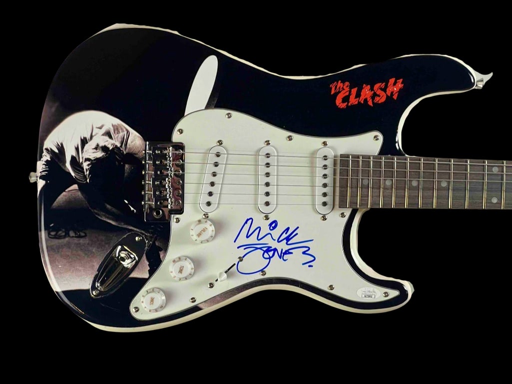 The Clash: Mick Jones Signed "London Calling" Themed Fender-Style Guitar (JSA): Custom electric Fender-style guitar featuring the iconic imagery and logo from The Clash’s legendary album "London Calling," signed on the pickguard in blue felt tip marker by guitarist Mick