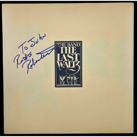 The Band: Robbie Robertson Signed "The Last Waltz" Album Booklet (Beckett): "The Last Waltz" album booklet signed on the cover in blue felt tip marker by The Band band member Robbie Robertson, who inscribed the message "To John" before his signature. Measuring approximately