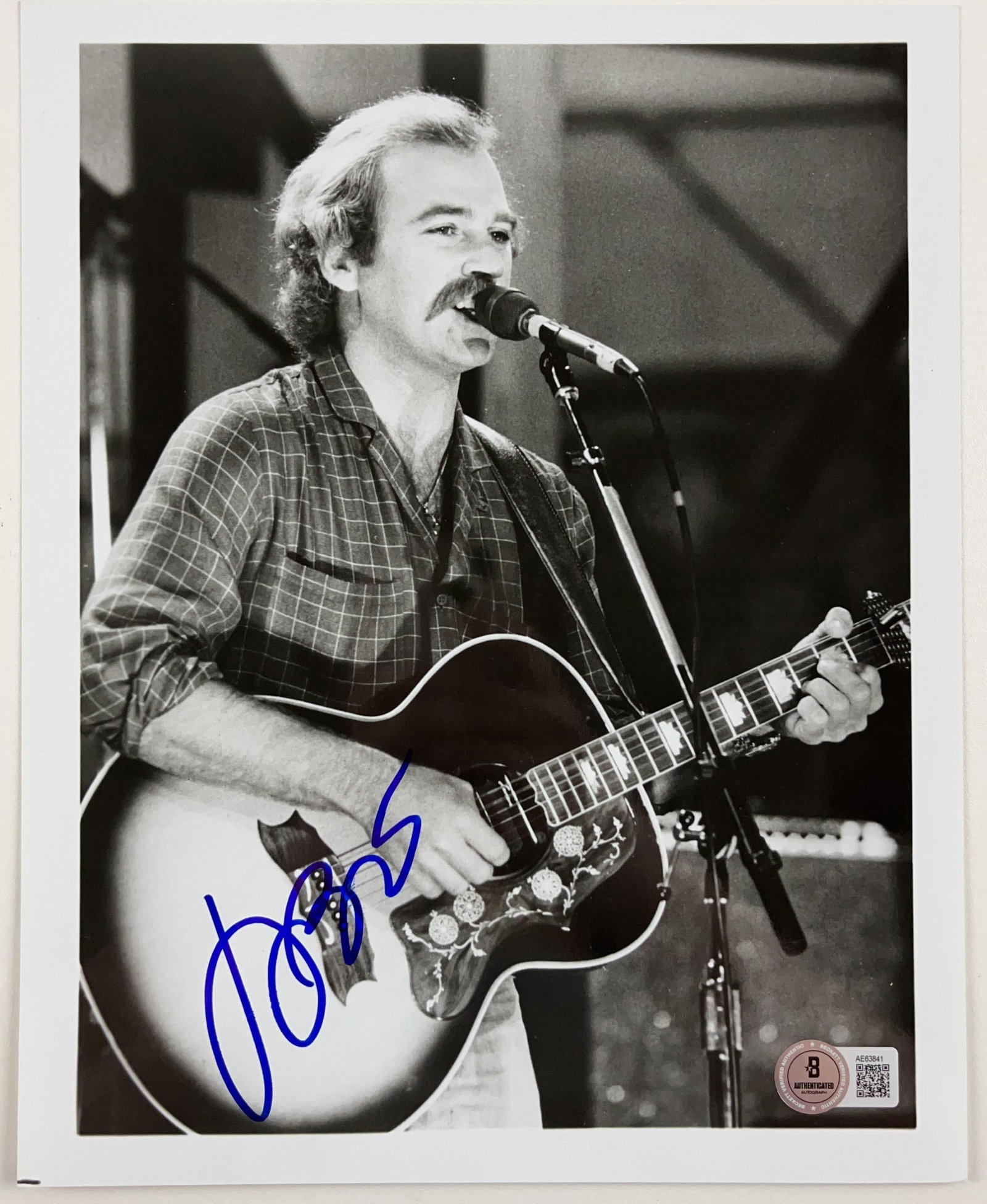 Jimmy Buffett Signed 10" x 8" Photo (Bekett Authentication): Black-and-white 10" x 8" photo signed in blue felt tip marker by musician Jimmy Buffett. In fine condition. Accompanied by a full Letter of Authenticity from Beckett (#AE63841). Obtained in-person.
