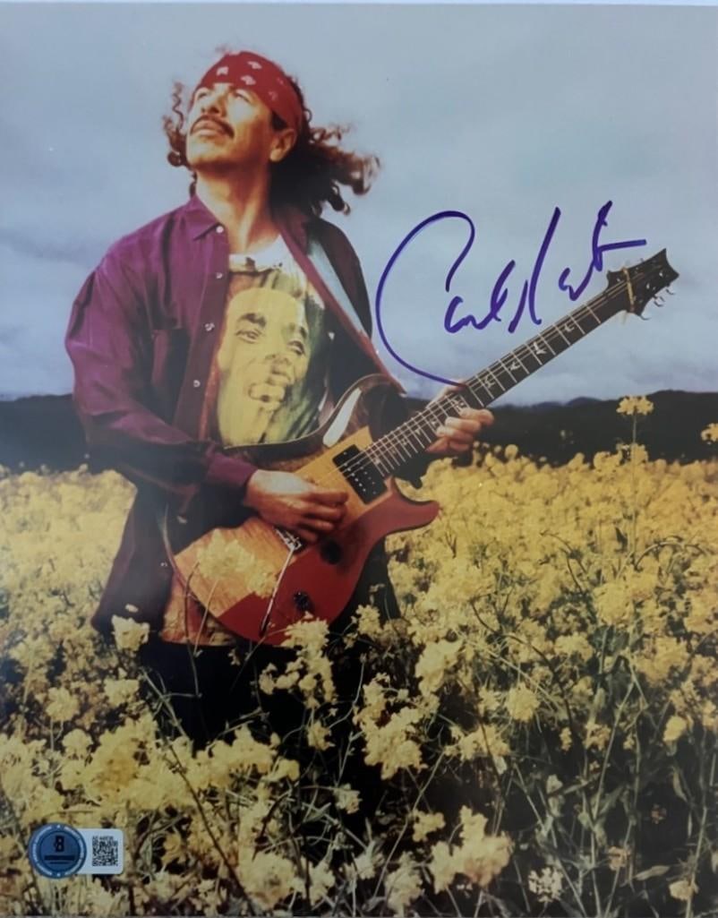 Carlos Santana Signed 10" x 8" Photo (Beckett Authentication): Color 10" x 8" photo signed in blue felt tip marker by musician Carlos Santana. In fine condition. Accompanied by a full Letter of Authenticity from Beckett (#AE44836).