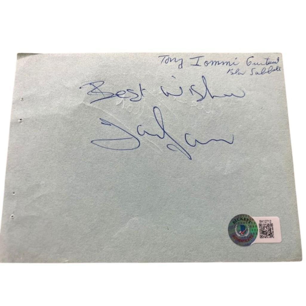 Black Sabbath: Tony Iommi & Ian Gillian Signed 5" x 6" Paper Cut (2 Sigs) (Beckett Authentication): White 5" x 6" paper cut signed on one side in blue ballpoint pen by Black Sabbath band member Tony Iommi, who also inscribed the message "Best wishes" before his signature. Back side signed in blue ba